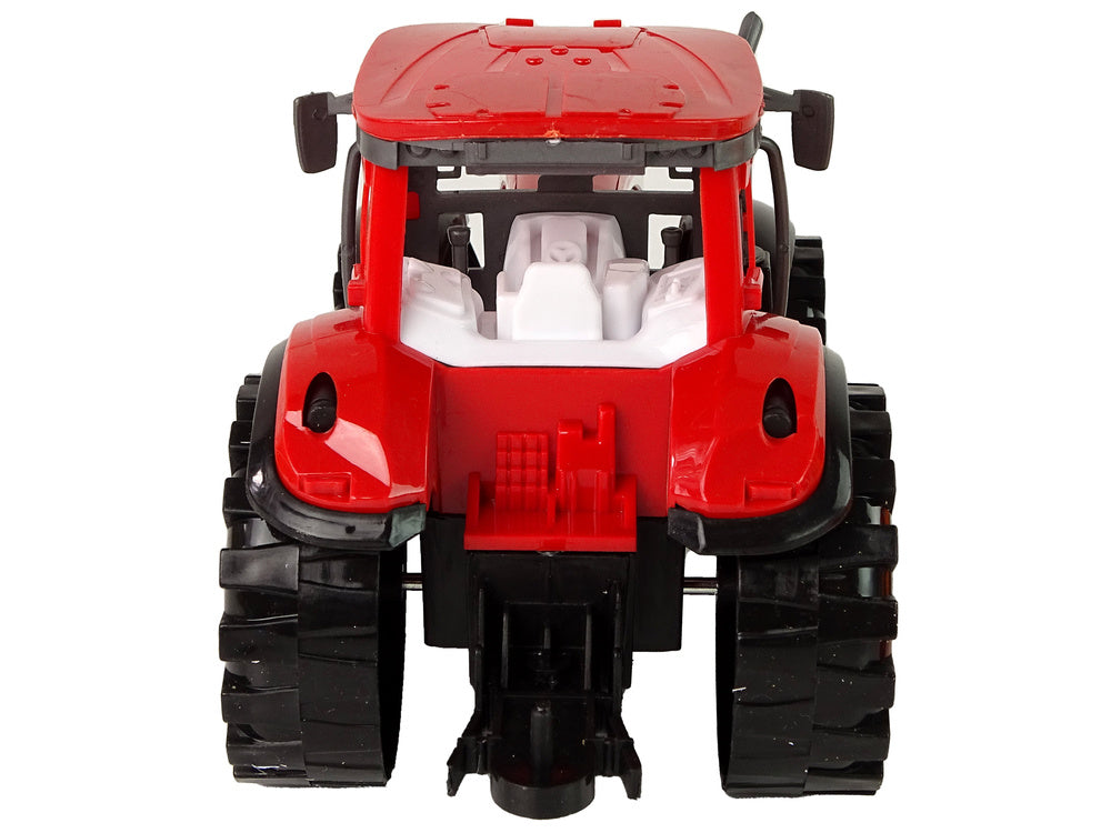 Tracteur rouge avec entraînement de cultivateur orange