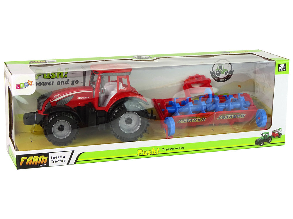 Tracteur rouge avec entraînement par friction de la charrue