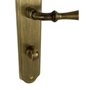 2 poignées de porte sur plaque CARINA, Verrou de condamnation pour salle de bain/WC, Finition laiton patiné, Entraxe standard 195 mm